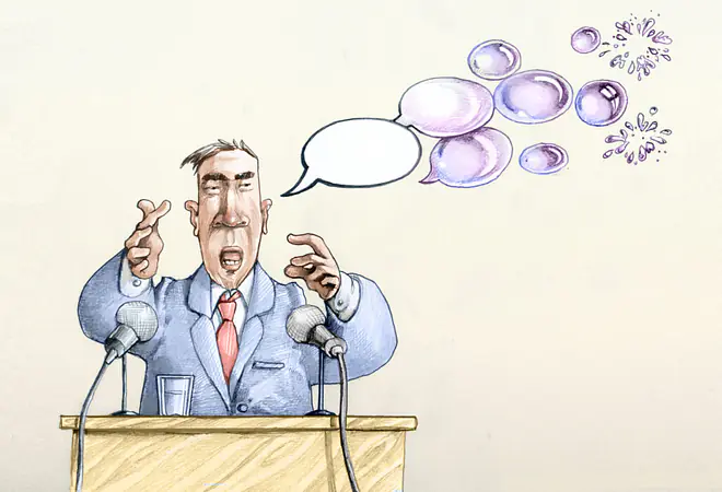 Ein Cartoon zeigt einen Mann im Anzug an einem Rednerpult. 