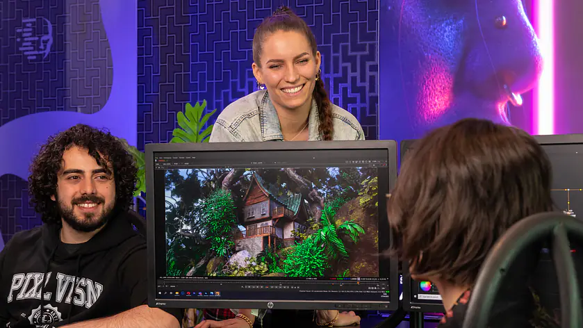 PIXL VISN Studenten posieren für ein Foto im Klassenraum mit einem Bildschirm wo ein 3D Rendering zusehen ist